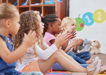Learning made fun. Shot of children clapping hands while sitting in class.