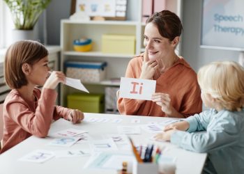 Woman teaching English children